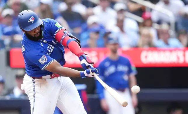 Toronto Blue Jays' Vladimir Guerrero Jr. hits a solo home run while playing against the Baltimore Orioles during the fifth inning of a baseball game in Toronto, Sunday, Sept. 13, 2026. (Nathan Denette/The Canadian Press via AP)