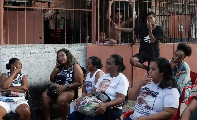 Mothers whose sons were killed by police attend a tribute event in the Morro da Crianca favela in Rio de Janeiro, Saturday, Sept. 19, 2026. (AP Photo/Bruna Prado)