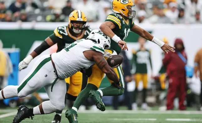 Green Bay Packers quarterback Jordan Love (10) is tackled by New York Jets defensive end Jowon Briggs (91) during an NFL football game in East Rutherford, N.J., Sunday, Sept. 20, 2026. (AP Photo/Adam Hunger)