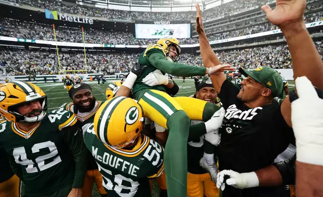Green Bay Packers kicker Trey Smack (28) is lifted in celebration by his teammates after kicking the game-winning field goal during an NFL football game against the New York Jets in East Rutherford, N.J., Sunday, Sept. 20, 2026. (AP Photo/Adam Hunger)