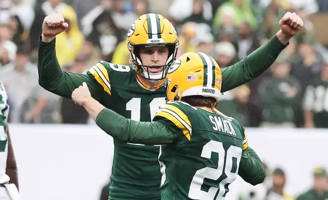 Green Bay Packers punter Daniel Whelan (19) and Packers kicker Trey Smack (28) celebrate the game-winning field goal during an NFL football game against the New York Jets in East Rutherford, N.J., Sunday, Sept. 20, 2026. (AP Photo/Adam Hunger)
