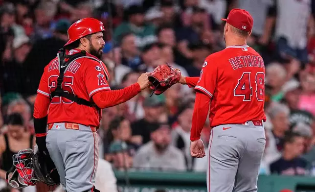 Los Angeles Angels starting pitcher Reid Detmers (48) is congratulated by catcher Travis D'Arnaud after his one hit outing against the Boston Red Sox following the sixth inning of a baseball game, Tuesday, Sept. 8, 2026, in Boston. (AP Photo/Charles Krupa)