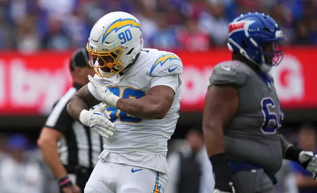 Los Angeles Chargers linebacker Akheem Mesidor (90) celebrates after a sack during the second half of an NFL football game against the Buffalo Bills, Sunday, Sept. 27, 2026, in Orchard Park, N.Y. (AP Photo/Matt Rourke)