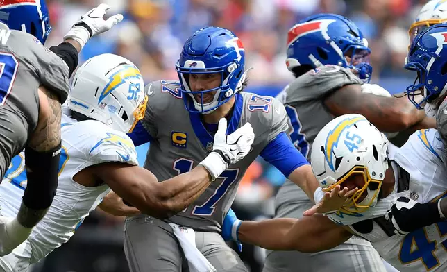 Buffalo Bills quarterback Josh Allen (17) is sacked by Los Angeles Chargers linebacker Khalil Mack (52) and linebacker Tuli Tuipulotu (45) during the second half of an NFL football game, Sunday, Sept. 27, 2026, in Orchard Park, N.Y. (AP Photo/Adrian Kraus)