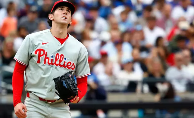 Philadelphia Phillies pitcher Andrew Painter reacts after giving up a home run to New York Mets' Carson Benge during the second inning of a baseball game, Saturday, Sept. 19, 2026, in New York. (AP Photo/Noah K. Murray)