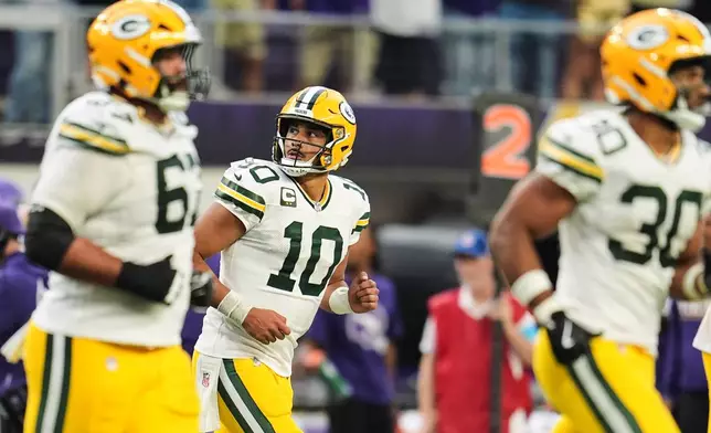 Green Bay Packers quarterback Jordan Love (10) and the offense jog off the field after Love threw an interception during the second half of an NFL football game against the Minnesota Vikings, Sunday, Sept. 13, 2026, in Minneapolis, Minn. (AP Photo/Abbie Parr)