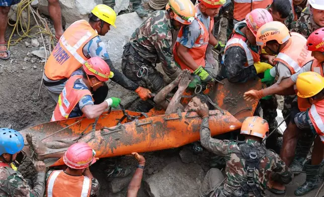 In this photo provided by the Nepal Army, soldiers rescue a worker alive from a tunnel during an ongoing operation at the Trishuli-3A hydropower project in Nepal's Rasuwa district, Friday, Sept. 4, 2026. (Nepal Army via AP)