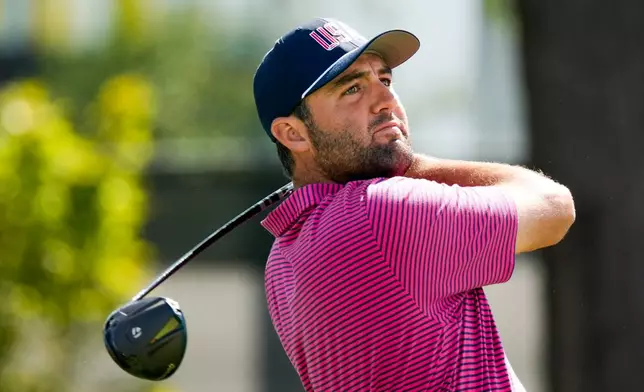 USA teams' Scottie Scheffler hits from the third tee against the International team during a Presidents Cup golf tournament final round singles match at Medinah Country Club, Sunday, Sept. 27, 2026, in Medinah, Ill. (AP Photo/Chris Carlson)