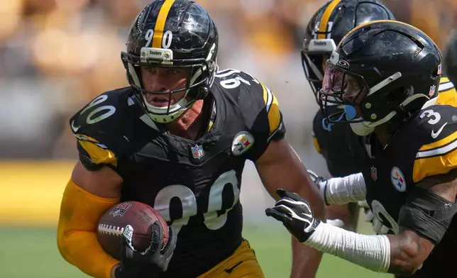 Pittsburgh Steelers outside linebacker T.J. Watt (90) returns an interception in for a touchdown during an NFL football game, Sunday, Sept. 13, 2026, in Pittsburgh. (AP Photo/Gene J. Puskar)