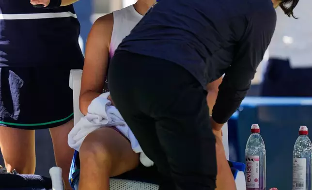 Iga Swiatek, of Poland, receives a massage during a medical timeout durnig a match against Qinwen Zheng, of China, during the fourth round of the U.S. Open tennis championships, Monday, Sept. 7, 2026, in New York. (AP Photo/Seth Wenig)