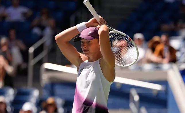Iga Swiatek, of Poland, reacts during a match against Qinwen Zheng, of China, during the fourth round of the U.S. Open tennis championships, Monday, Sept. 7, 2026, in New York. (AP Photo/Seth Wenig)