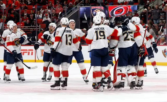 Florida Panthers celebrate their 2-1 win over the Carolina Hurricanes following an NHL hockey game in Raleigh, N.C., Tuesday, Sept. 29, 2026. (AP Photo/Karl DeBlaker)