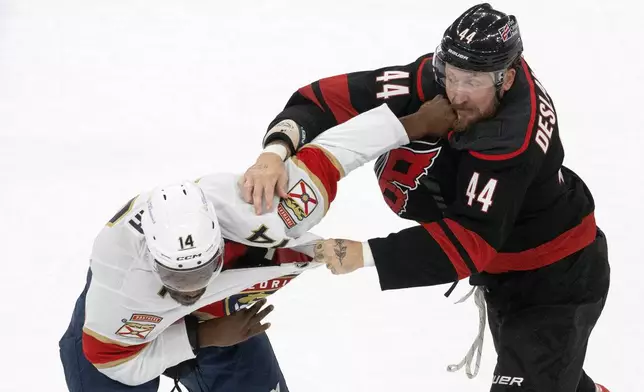 Carolina Hurricanes' Nicolas Deslauriers (44) exchanges blows with Florida Panthers' Bokondji Imama (14) during the first period of an NHL hockey game in Raleigh, N.C., Tuesday, Sept. 29, 2026. (AP Photo/Karl DeBlaker)