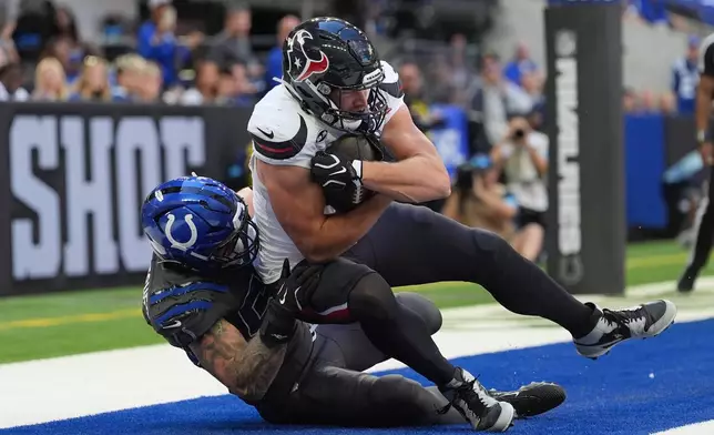 Houston Texans tight end Foster Moreau, right, catches a pass for touchdown as Indianapolis Colts linebacker Bryce Boettcher defends during the first half of an NFL football game, Sunday, Sept. 27, 2026, in Indianapolis. (AP Photo/Jeff Roberson)