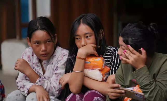 Displaced girls sit at a school converted into a temporary shelter for displaced residents in residents in Bidur, in Nepal's Nuwakot district, Tuesday, Sept. 1, 2026. (AP Photo/Rajesh Kumar Singh)