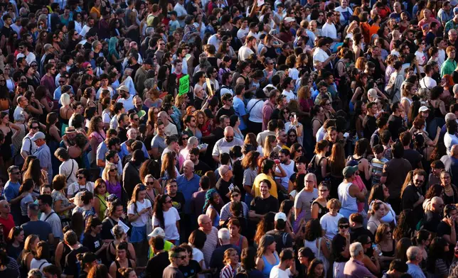 People gather during a protest following the eviction last Wednesday of 87-year-old Maricarmen to demand stronger laws to protect renters at Puerta del Sol in Madrid, Spain, Saturday, Sept. 26, 2026. (AP Photo/Manu Fernandez)