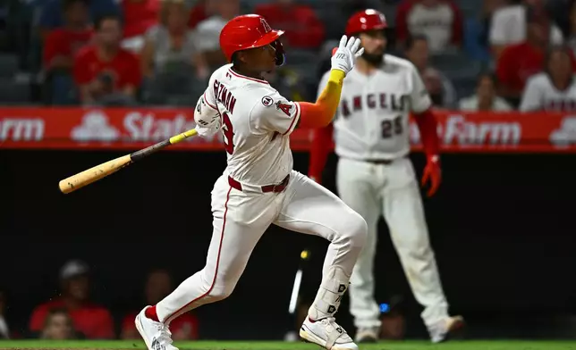 Los Angeles Angels' Denzer Guzman watches his RBI single during the fifth inning of a baseball game against the Seattle Mariners, Monday, Sept. 14, 2026, in Anaheim, Calif. (AP Photo/William Liang)