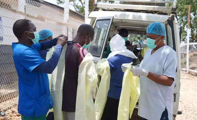 Health workers who are members of the safe and dignified burial team prepare to bury Abineno Justine, a 38 year old woman who died of the Ebola virus, in Bunia, Congo, Friday, Sept. 4, 2026. (AP Photo/Dieudonne Dirole)