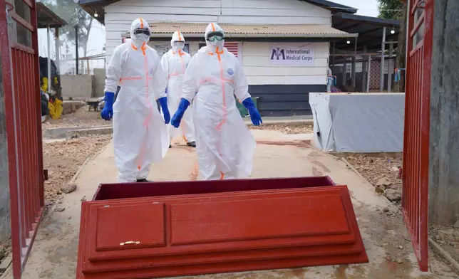 Health workers who are members of the safe and dignified burial team prepare to bury Abineno Justine, a 38 year old woman who died of the Ebola virus, in Bunia, Congo, Friday, Sept. 4, 2026. (AP Photo/Dieudonne Dirole)