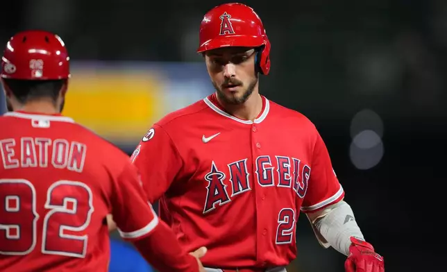 Los Angeles Angels' Bryce Teodosio celebrates an RBI single with first base/outfield coach Adam Eaton (92) during the eighth inning of a baseball game against the Seattle Mariners, Thursday, Sept. 24, 2026, in Seattle. (AP Photo/Lindsey Wasson)