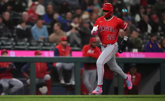 Los Angeles Angels' Denzer Guzman scores on an RBI single by Bryce Teodosio against the Seattle Mariners during the eighth inning of a baseball game, Thursday, Sept. 24, 2026, in Seattle. (AP Photo/Lindsey Wasson)