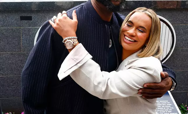 Hall of Famer CC Sabathia hugs his wife Amber, after unveiling his number during his Monument Park induction ceremony before a baseball game between the New York Yankees and Baltimore Orioles, Friday, Sept. 25, 2026, in New York. (AP Photo/Noah K. Murray)