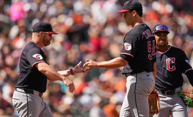 Cleveland Guardians starting pitcher Joey Cantillo (54) hands the ball to manager Stephen Vogt, left, while leaving the mound during a pitching substitution in the third inning of a baseball game against the Baltimore Orioles, Monday, Sept. 7, 2026, in Baltimore. (AP Photo/Stephanie Scarbrough)