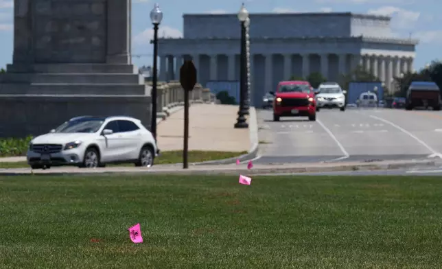 FILE - Flags placed by workers are pictured in the Memorial Circle, where President Donald Trump has proposed building an arch to commemorate the United States' 250th anniversary, Friday, May 15, 2026, in Washington. (AP Photo/Jacquelyn Martin, File)