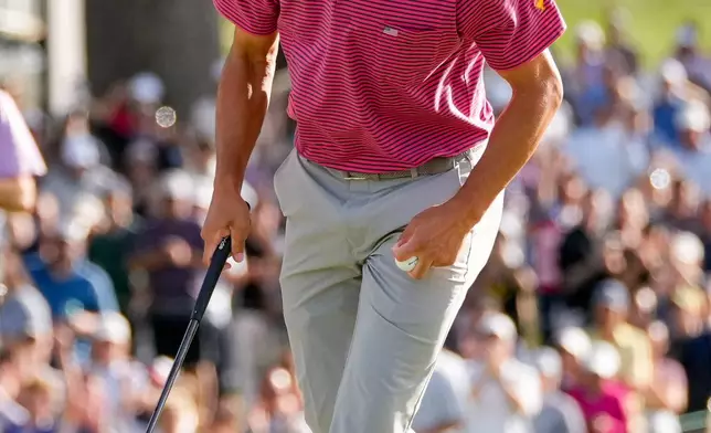 USA teams' Collin Morikawa celebrates his win over International teams' Hideki Matsuyama, of Japan, after their Presidents Cup golf tournament final round singles match at Medinah Country Club, Sunday, Sept. 27, 2026, in Medinah, Ill. (AP Photo/Chris Carlson)