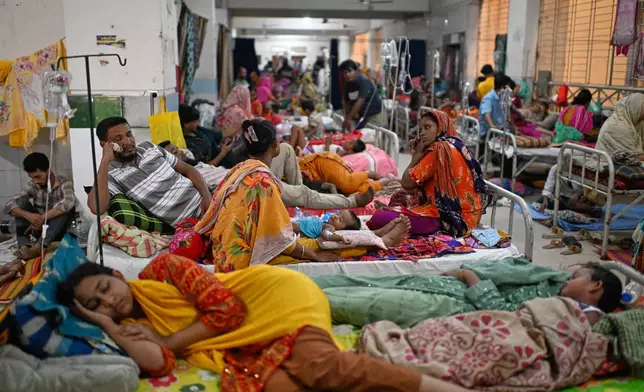 Patients receive treatment during a measles outbreak as family members sit beside them in an overcrowded hospital in Dhaka, Bangladesh, Tuesday, Sept. 8, 2026. (AP Photo/Mahmud Hossain Opu)