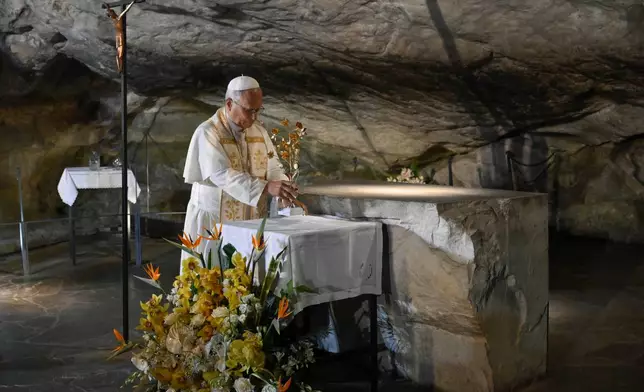 In this handout photo provided by Vatican Media Pope Leo XIV prays at the Grotto of the Apparitions of Massabielle, in Lourdes, France, Saturday, Sept. 26, 2026. (Vatican Media via AP)