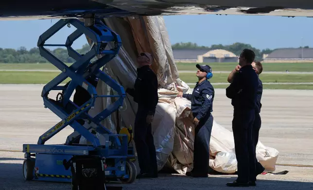 U.S> Air Force personnel work after an emergency inflatable slide deployed before President Donald Trump arrived to board at Joint Base Andrews, Md., Wednesday, Sept. 9, 2026. (AP Photo/Jacquelyn Martin)