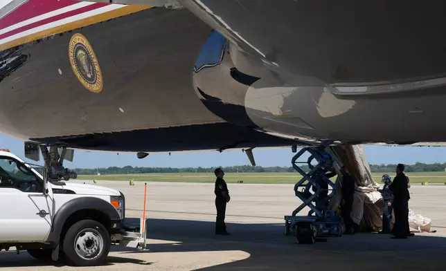 U.S. Air Force personnel work after an emergency inflatable slide deployed on Air Force One before President Donald Trump arrived to board at Joint Base Andrews, Md., Wednesday, Sept. 9, 2026. (AP Photo/Jacquelyn Martin)