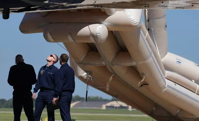 U.S, Air Force personnel work after an emergency inflatable slide deployed before President Donald Trump arrived to board at Joint Base Andrews, Md., Wednesday, Sept. 9, 2026. (AP Photo/Jacquelyn Martin)