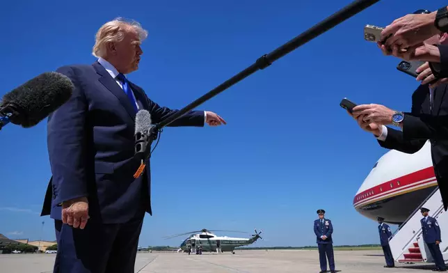 President Donald Trump talks with reporters after an emergency inflatable slide deployed on Air Force One before before Trump arrived to board at Joint Base Andrews, Md., Wednesday, Sept. 9, 2026. (AP Photo/Jacquelyn Martin)