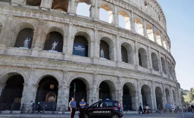 Carabinieri paramilitary police stand on patrol outside the Colosseum, closed to the public for the day to mourn a worker who fell to his death late Tuesday when installing cabling inside the ancient amphitheater, in Rome, Wednesday, Sept. 23, 2026. (Cecilia Fabiano/LaPresse via AP)