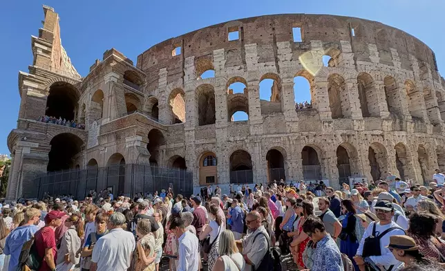 Tourists wait to enter the Colosseum, closed to the public for the day to mourn a worker who fell to his death late Tuesday while installing cabling inside the ancient amphitheater, in Rome, Wednesday, Sept. 23, 2026. (AP Photo/Domenico Stinellis)