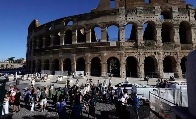 Tourists gather outside the Colosseum, closed to the public for the day to mourn a worker who fell to his death late Tuesday when installing cabling inside the ancient amphitheater, in Rome, Wednesday, Sept. 23, 2026. (Cecilia Fabiano/LaPresse via AP)