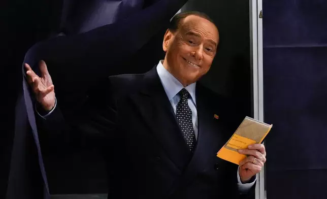 FILE - Silvio Berlusconi, leader of center-right, populist Forza Italia exits a voting booth before casting his ballot at a polling station in Milan, Italy, Sept. 25, 2022. (AP Photo/Antonio Calanni, File)