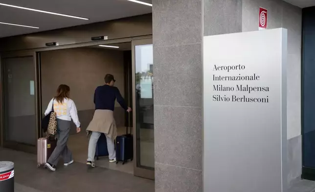 Passengers arrive at Italy’s second-busiest airport, Milan Malpensa, that was officially named after the late former Premier Silvio Berlusconi, in Somma Lombardo, Italy, Friday, Sept. 25, 2026. (Marco Ottico/LaPresse via AP)
