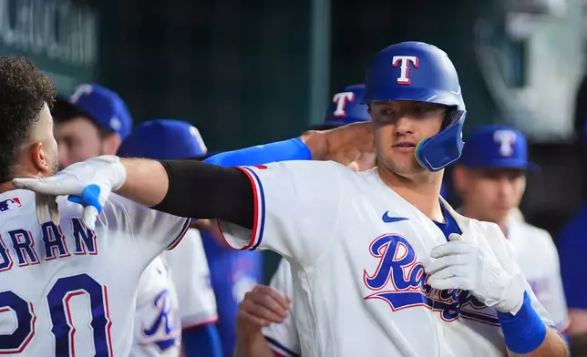 Texas Rangers' Josh Jung reacts in the dugout after hitting a two-run home run against the New York Mets during the first inning of a baseball game Thursday, Sept. 24, 2026, in Arlington, Texas. (AP Photo/Julio Cortez)
