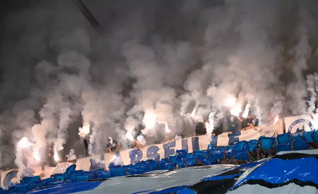 Marseille fans light flares prior to the French League One soccer match between Marseille and Paris Saint-Germain in Marseille, France, Sunday, Sept. 20, 2026. (AP Photo/Philippe Magoni)
