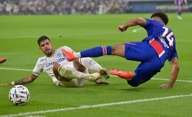 PSG's Desire Doue, right, falls on the pitch challenged by Marseille's Emerson Palmieri during the French League One soccer match between Marseille and Paris Saint-Germain in Marseille, France, Sunday, Sept. 20, 2026. (AP Photo/Philippe Magoni)