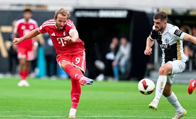 Elversberg's Lukasz Poreba, right, and Munich's Harry Kane left, challenge for the ball during the German Bundesliga soccer match between SV Elversberg and FC Bayern Munich in Elversberg, Germany, Sunday, Sept. 13, 2026. (Uwe Anspach/dpa via AP)