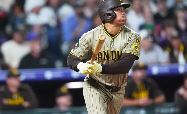 San Diego Padres' Dustin Harris breaks from the batter's box after connecting for an RBI triple off Colorado Rockies starting pitcher Mason Adams in the fourth inning of a baseball game Wednesday, Sept. 16, 2026, in Denver. (AP Photo/David Zalubowski)