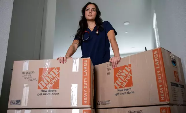 Dariela Merchan, a registered nurse, poses for a portrait at her home on Friday, Sept. 4, 2026, in Georgetown, Texas. Merchan is organizing supplies to be shipped to people in Venezuela recovering from June's twin earthquakes. (AP Photo/Joel Angel Juarez)