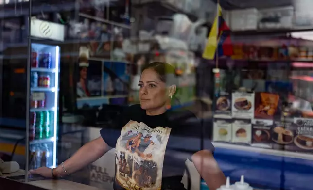 Kelly Granado, whose parents died in Venezuela's June 24 earthquakes, poses for photos at her restaurant in downtown Los Angeles, Tuesday, Aug. 25, 2026. (AP Photo/Jae C. Hong)