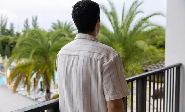 Alejandro Marquina, seen from behind, looks toward the horizon on Saturday, Aug. 29, 2026, in Doral, Fla. (AP Photo/David Santiago)
