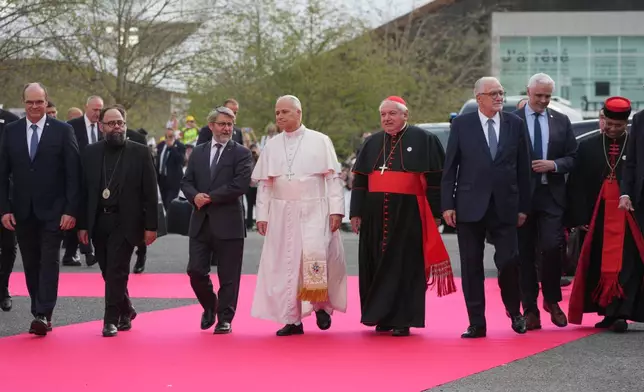 Pope Leo XIV, center, arrives, with, from left, Christian Krieger, president of the Protestant Federation of France, Bishop Dimitrios (Ploumis), the Greek Orthodox Metropolitan of France, Haïm Korsia, Chief Rabbi of France, President of the French Bishops' Conference, Cardinal Jean-Marc Aveline, Chems-eddine Hafiz, rector of the Grand Mosque of Paris, Anthony Boussemart, representing French Buddhists, and Cardinal George Jacob Koovakad, prefect of the Dicastery for Interreligious Dialogue, to attend an interreligious meeting at the Robert Schuman Convention Centre, Monday, Sept. 28, 2026, in Metz, France. (AP Photo/Gregorio Borgia) ADDITION: Add names of persons in the photo