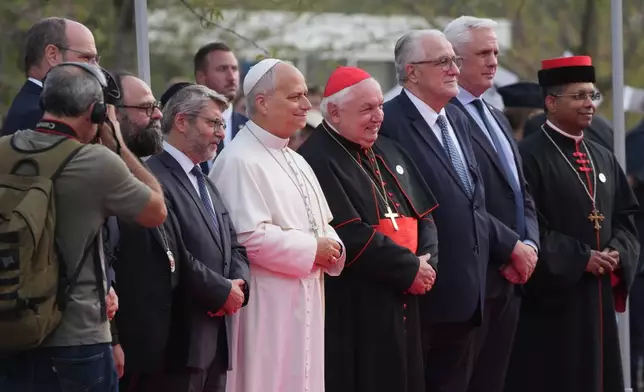 Pope Leo XIV, center, arrives, with, from left, Christian Krieger, president of the Protestant Federation of France (partially covered, Bishop Dimitrios (Ploumis), the Greek Orthodox Metropolitan of France, Haïm Korsia, Chief Rabbi of France, President of the French Bishops' Conference, Cardinal Jean-Marc Aveline, Chems-eddine Hafiz, rector of the Grand Mosque of Paris, Anthony Boussemart, representing French Buddhists, and Cardinal George Jacob Koovakad, prefect of the Dicastery for Interreligious Dialogue, to attend an interreligious meeting at the Robert Schuman Convention Centre, Monday, Sept. 28, 2026, in Metz, France. (AP Photo/Gregorio Borgia)